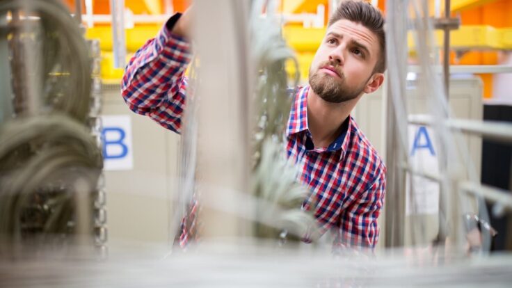 Technician Looking At Cables Of The Server
